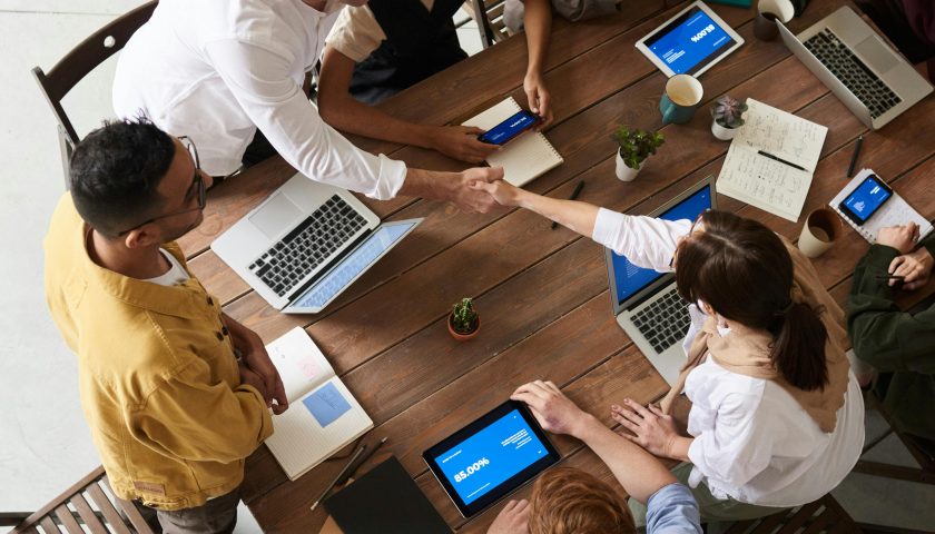 Overhead shot of a diverse team collaborating in a modern office meeting.